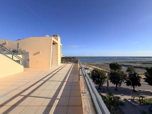 a view of the beach from the balcony of a building at Casa Joaninha in Olhão