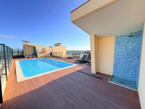 a swimming pool on the deck of a house at Casa Joaninha in Olhão