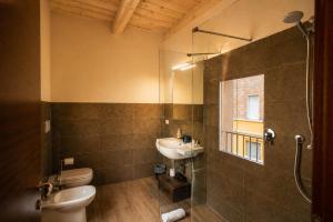 a bathroom with a sink and a toilet and a shower at Al Battistero Luxury Suite in Ravenna +76 photos
