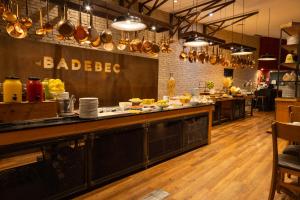 a kitchen with a counter with plates of food at Radisson Vila Olimpia Sao Paulo in São Paulo