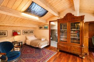 a bedroom with a bed and a wooden ceiling at Al Battistero Luxury Suite in Ravenna