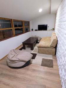 a living room with a couch and a table at KOPILOVE in Foča