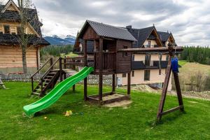a playground with a tree house and a slide at Pokoje gościnne u Eli i Jacka in Murzasichle