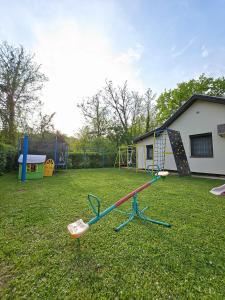 a playground with a seesaw in a yard at Vikendica Fruškogorski kutak - Fruška Gora in Čerević