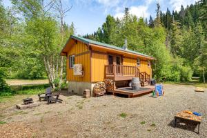 a small yellow house with a porch and a patio at Cle Elum Cabin on the Yakima River! in Cle Elum