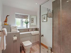 a bathroom with a shower and a toilet and a sink at 1 Bed in Shepton Mallet oc-94296 in Pilton +9 photos