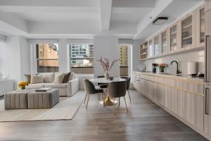 a kitchen and living room with a couch and a table at 17John Residences in New York