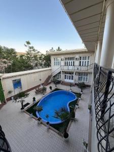 an overhead view of a building with a swimming pool at Global Star Hotel in Samarkand