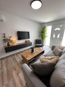a living room with a couch and a coffee table at Oleana Cosy Studio in Lampi
