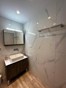 a bathroom with a sink and a glass shower at Oleana Cosy Studio in Lampi +14 photos