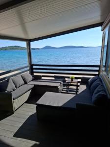 a boat with couches and a view of the ocean at Villa Petra 1 in Vodice