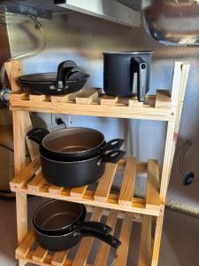 a couple of shelves with pots and pans on them at Chalés Champion Capitolio in Capitólio