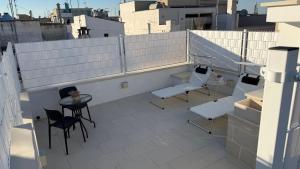 a balcony with chairs and a table on a building at Samy Suite in Fasano