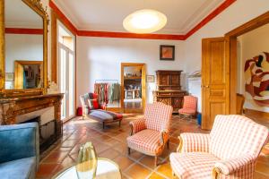 a living room with chairs and a fireplace at Domaine La Cournonsécoise in Cournonsec