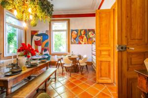 a dining room with a table and chairs at Domaine La Cournonsécoise in Cournonsec +21 photos