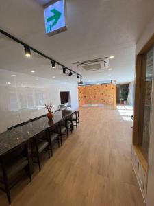 a large room with tables and a tv on the wall at コテージ銚子百里 in Hasaki