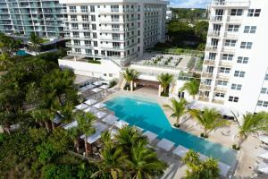 an aerial view of a pool with palm trees and buildings at Fort Lauderdale Marriott Pompano Beach Resort in Pompano Beach