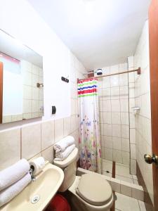 a bathroom with a toilet and a sink and a shower at Mirador All Sur Cusco in Cusco +44 photos