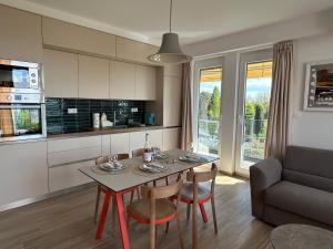 a kitchen and living room with a table and chairs at SANI Apartments by Kanevce in Ohrid
