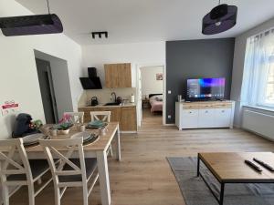 a living room with a table and a dining room at Apartament between the bridges II in Zgorzelec +17 photos