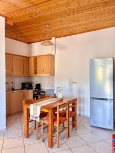 a kitchen with a table and a refrigerator at Albatros rooms in Vathi +33 photos