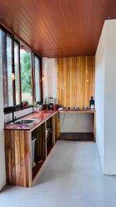 a kitchen with a sink and a counter top at Villa Monarca in Ayampe