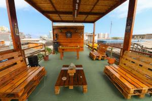 a balcony with wooden benches and a clock on a building at Mediterraneo Hotel in Iquique