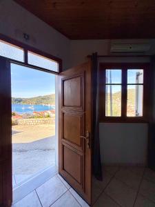 an open door to a room with a view of the beach at Albatros rooms in Vathi