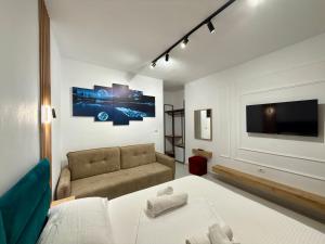 a living room with a bed and a couch at Full Moon Apartments in Ksamil