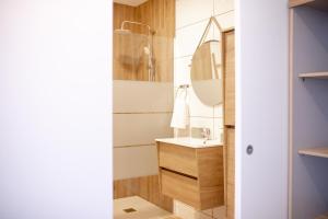 a bathroom with a sink and a mirror at Cantinho FF in Santana +18 photos