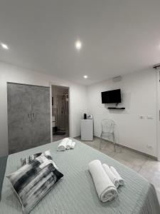 a bedroom with a bed with two towels on it at Marluna in Custonaci