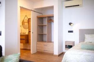 a bedroom with a bed and a walk in closet at Cantinho FF in Santana