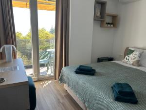 a bedroom with a bed with two blue towels on it at SANI Apartments by Kanevce in Ohrid +38 photos
