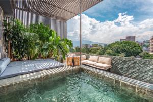 a swimming pool in the middle of a building at Hotel Zelva Negra in Medellín