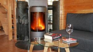 a living room with a fireplace and a glass table at Ferienhaus Milan mit Ruderboot - 300 m vom Fleesensee in Silz
