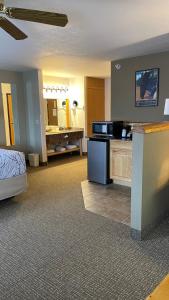 a hotel room with a bed and a bathroom at The Antler Lodge - Gardiner in Gardiner