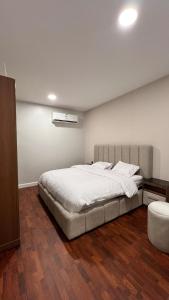a bedroom with a large white bed in a room at The Calm Suite in Al Khobar