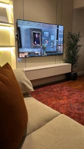 a living room with a large flat screen tv at The Calm Suite in Al Khobar +10 photos