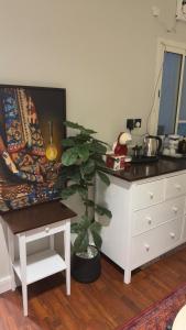 a kitchen with a table and a potted plant at The Calm Suite in Al Khobar