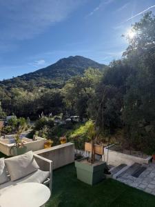 a patio with a view of a mountain at La forêt in Le Plan-de-la-Tour