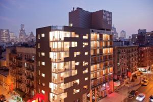 a tall building with many windows in a city at Nolitan Hotel SoHo - New York in New York