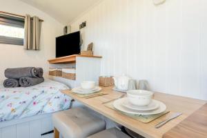 a room with a table with dishes on it with a bed at 1 Bed in Narberth oc-83862 in Whitland