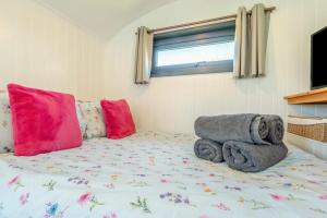 a bed with a teddy bear sitting on top of it at 1 Bed in Narberth oc-83862 in Whitland