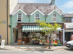 a man walking in front of a store at 1 Bed in Narberth oc-83862 in Whitland