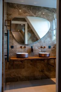 a bathroom with two sinks and a mirror at Room4 in Maurik +20 photos