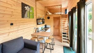 a tiny house with a table and stools at Cabane insolite en pleine nature - La cabane de Dim in Grumesnil