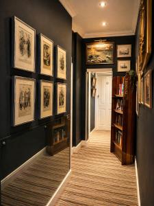 a hallway with black walls and a book shelf at The Royal Harbour Hotel in Ramsgate +157 photos