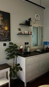 a kitchen with a counter top and a dresser at The Calm Suite in Al Khobar