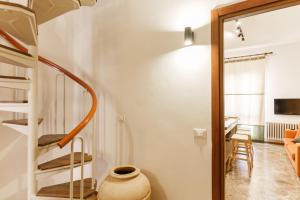 a room with a staircase and a living room at Residenza Subasio Assisi in Rivotorto