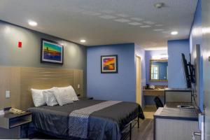 a hotel room with a bed and a television at Orange Tustin Inn in Orange in Orange